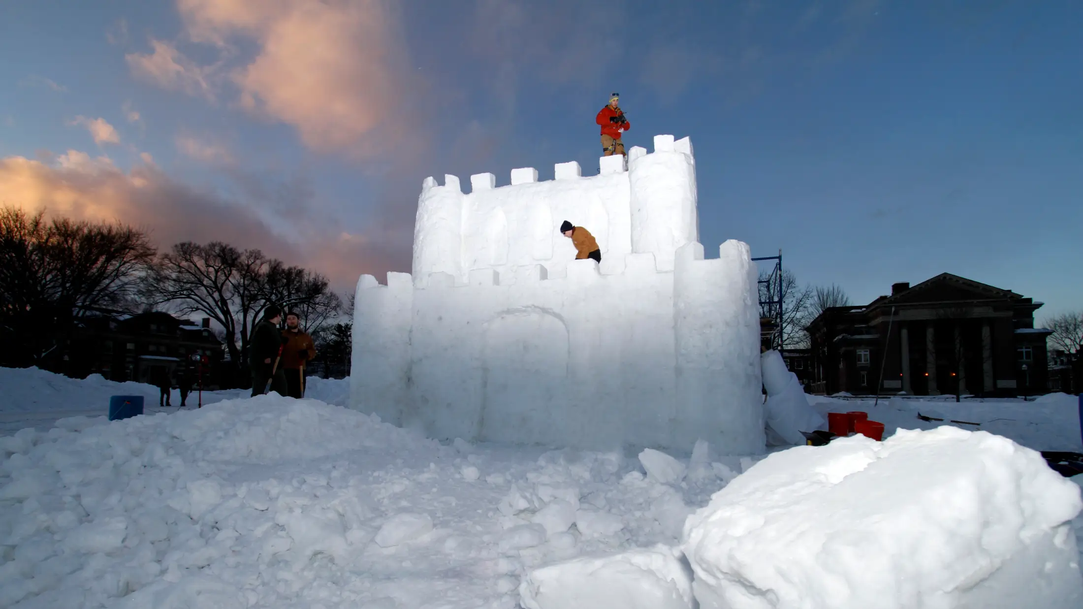 Dartmouth students build a castle-shaped snow fort on campus during the college’s winter carnival.