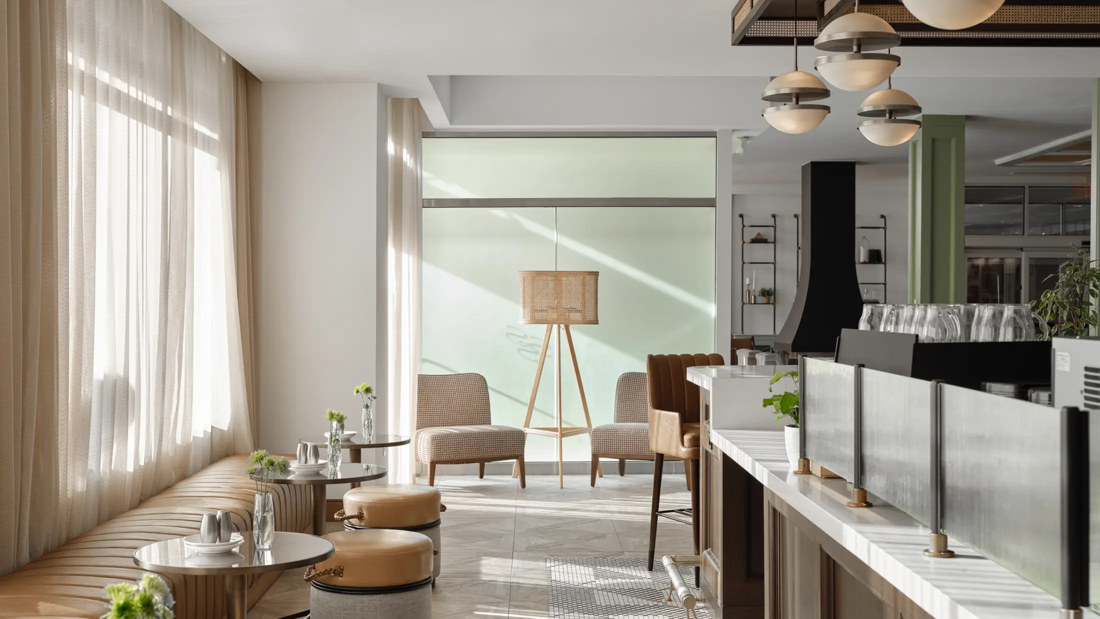 Sunny, window-lined seating areas in the lounge at Six South St Hotel, Hanover, New Hampshire