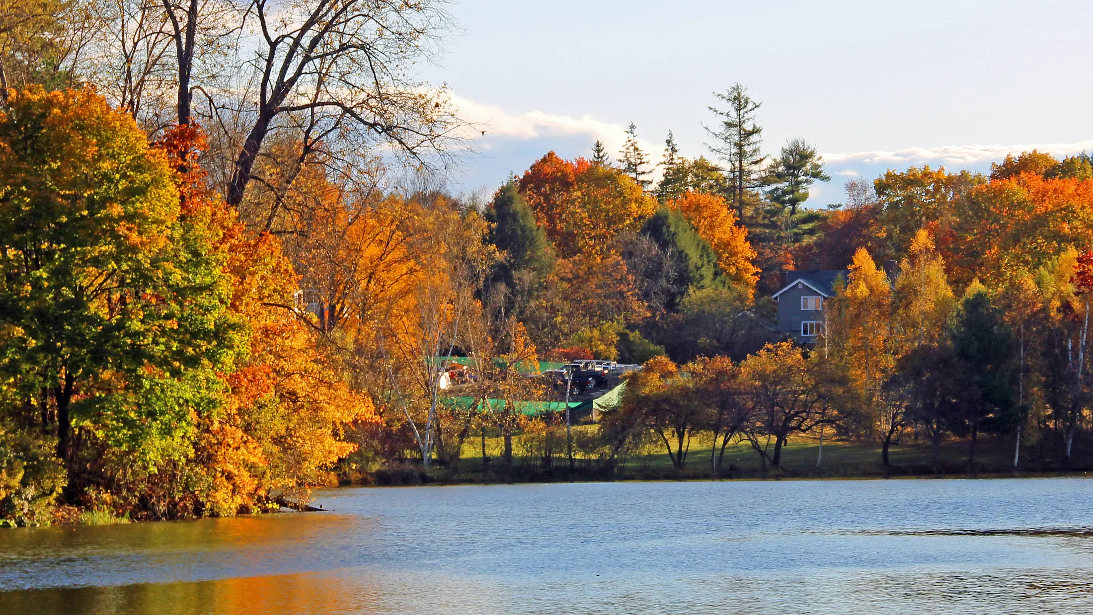 Colorful trees of autumn surround the water in greater Hanover, New Hampshire.
