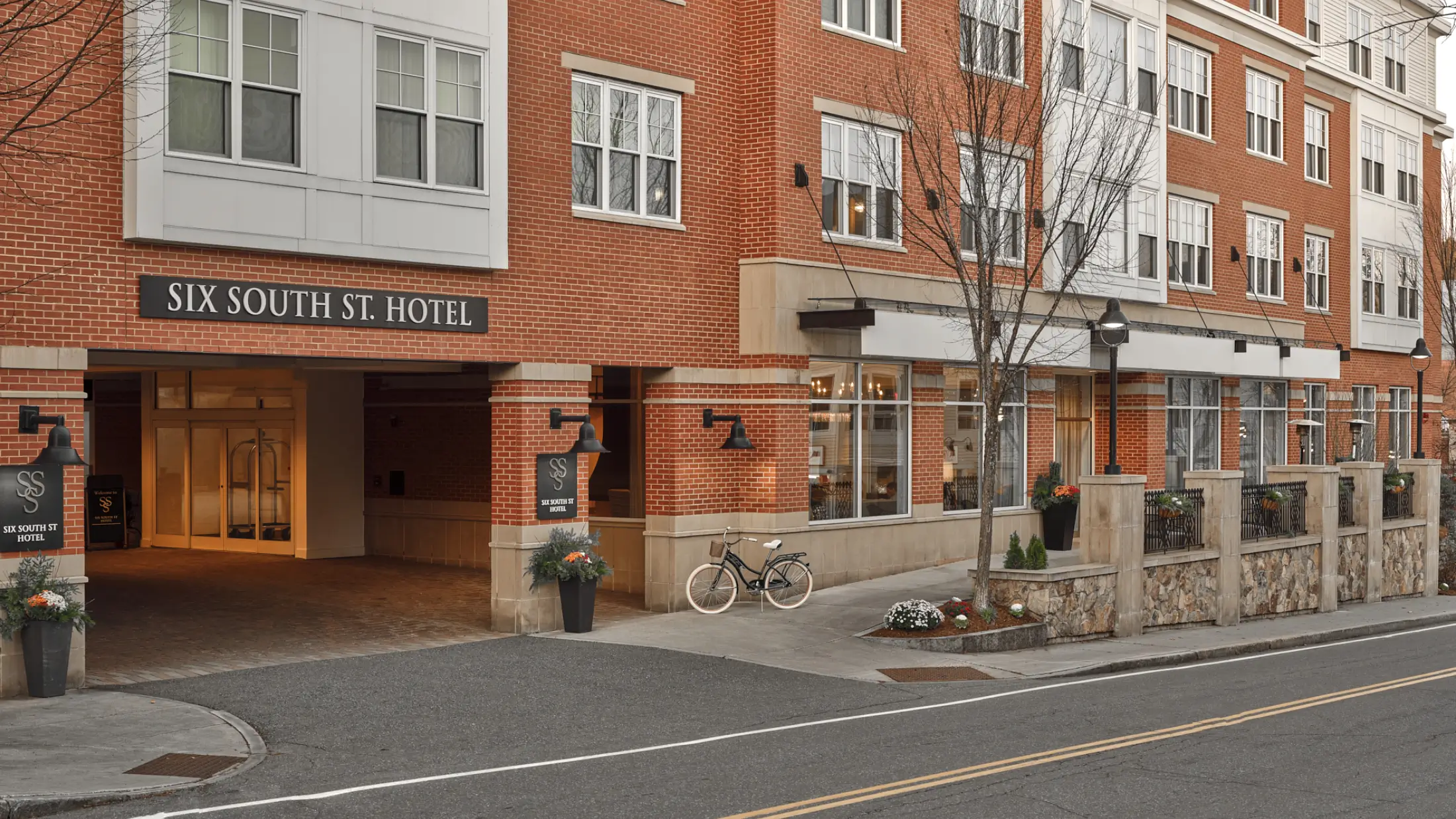 Visitor’s bicycle leans along front entryway of Six South St Hotel in Hanover, New Hampshire.