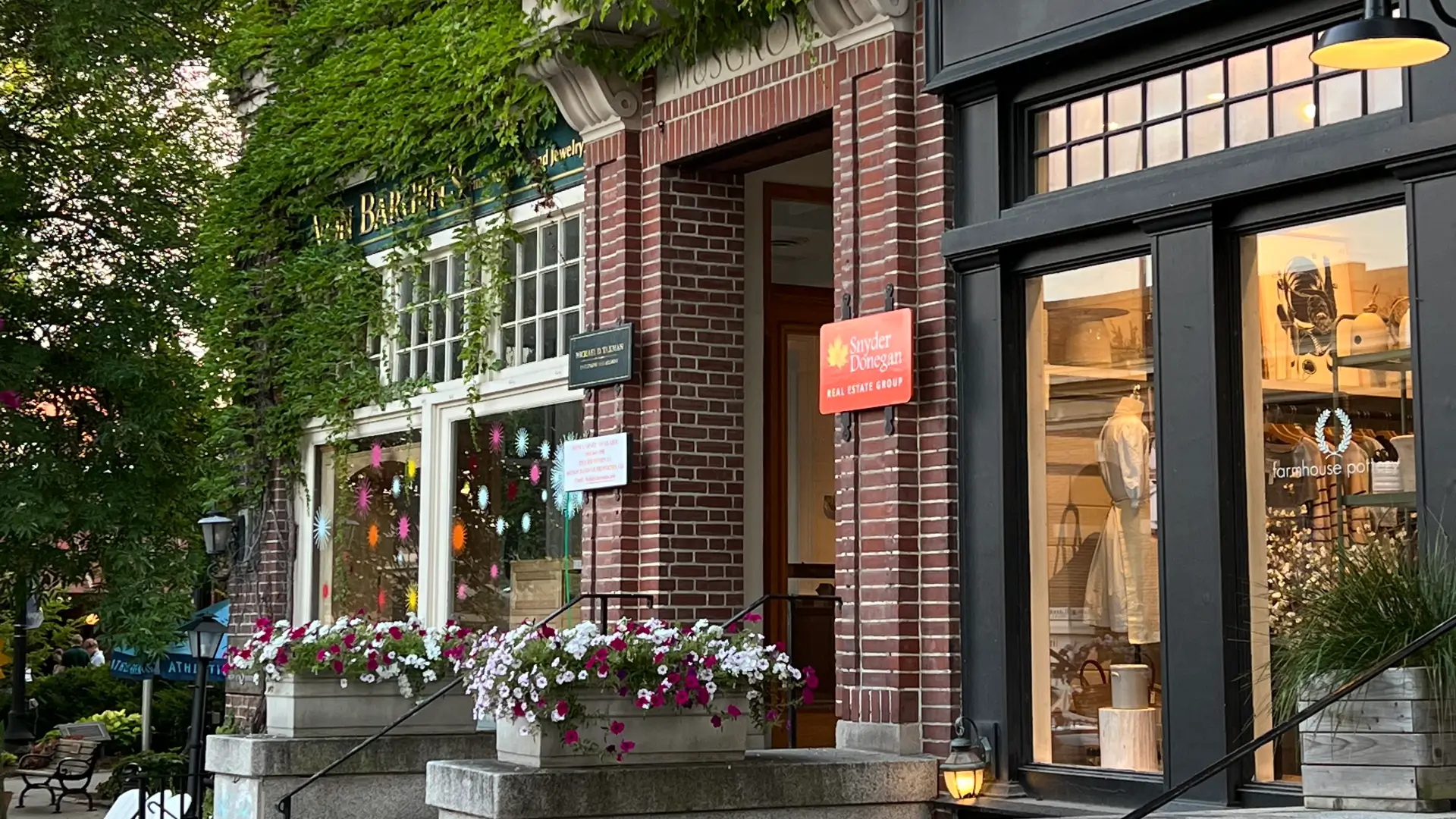 Shop windows decorated for summer on Main Street in downtown Hanover, New Hampshire.