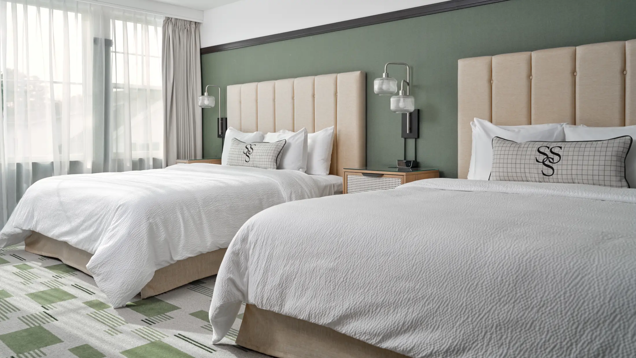 Double king guestroom with branded cushions, premium linens, and luxury amenities at Six South St Hotel in Hanover, NH.