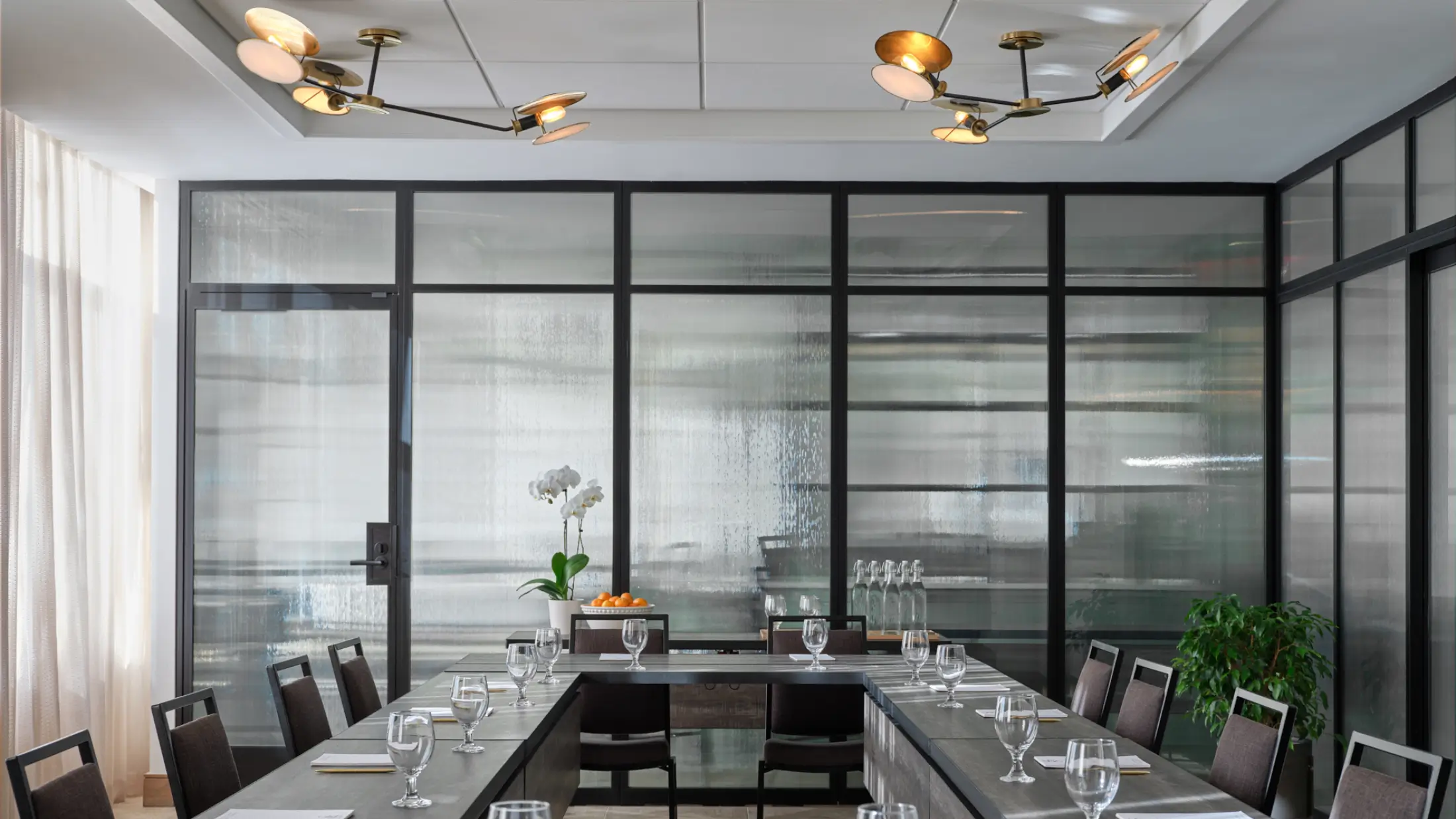 Well-lit, glass-enclosed meeting space at Six South St Hotel in Hanover, New Hampshire.